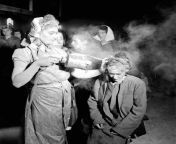 A woman newly liberated from the Bergen Belsen concentration camp being sprayed with DDT powder to kill lice which can spread typhus, May, 1945 from hlbalbums pk bergen